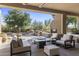 Relaxing covered patio with outdoor fireplace, offering views of the pool and landscaped backyard at 10040 E Happy Valley Rd # 479, Scottsdale, AZ 85255