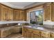 Laundry room boasting custom wood cabinets, tile countertops, and a view to backyard landscaping at 10040 E Happy Valley Rd # 479, Scottsdale, AZ 85255