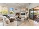 Bright living room with fireplace, large windows with mountain views, and sliding door access to the outside at 10040 E Happy Valley Rd # 479, Scottsdale, AZ 85255