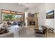 Elegant living room with a stone fireplace and seamless indoor-outdoor flow to a covered patio at 10040 E Happy Valley Rd # 479, Scottsdale, AZ 85255