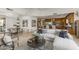 Spacious living room with stone floors, modern decor, and seamless flow into kitchen and dining areas at 10040 E Happy Valley Rd # 479, Scottsdale, AZ 85255