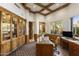 Home office with custom wood cabinets, beamed ceiling, and large view window at 10040 E Happy Valley Rd # 479, Scottsdale, AZ 85255