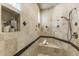 Luxurious travertine shower features a built-in bench and decorative accent tiles at 10040 E Happy Valley Rd # 479, Scottsdale, AZ 85255