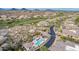 Stunning aerial view of a luxury community with a pool, spa, lush landscaping, and golf course with mountain views at 10260 E White Feather Ln # 1022, Scottsdale, AZ 85262