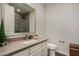 Well-lit half bathroom features stone countertop, white vanity, and modern fixtures at 10260 E White Feather Ln # 1022, Scottsdale, AZ 85262