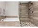Modern bathroom features a glass-enclosed shower with neutral tile surround and mosaic tile floor at 10260 E White Feather Ln # 1022, Scottsdale, AZ 85262