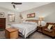 Bedroom with a queen-sized bed, lamps, and a woven chest at the foot of the bed at 10260 E White Feather Ln # 1022, Scottsdale, AZ 85262