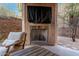 Cozy covered patio features a fireplace, ceiling fan, and seating area for relaxation at 10260 E White Feather Ln # 1022, Scottsdale, AZ 85262