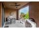 Relaxing covered patio featuring ceiling fan, table and chairs with desert landscape views at 10260 E White Feather Ln # 1022, Scottsdale, AZ 85262