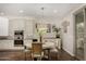 Charming dining area featuring modern lighting, an adjacent kitchen, and easy access to the outdoors at 10260 E White Feather Ln # 1022, Scottsdale, AZ 85262