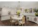 Dining area with wooden table, stylish light fixture, and art adorning the walls at 10260 E White Feather Ln # 1022, Scottsdale, AZ 85262