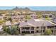 Exterior aerial view of Desert Highlands home with desert landscaping and mountain views at 10260 E White Feather Ln # 1022, Scottsdale, AZ 85262