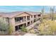 View of Desert Highlands home featuring covered patios, balconies, and desert landscape at 10260 E White Feather Ln # 1022, Scottsdale, AZ 85262