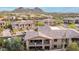 Exterior aerial view of Desert Highlands homes with desert landscaping and mountain views at 10260 E White Feather Ln # 1022, Scottsdale, AZ 85262