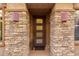 Inviting front entrance with decorative stone accents and stylish modern lighting fixtures at 10260 E White Feather Ln # 1022, Scottsdale, AZ 85262