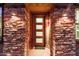 Stylish front entrance with stone accents, decorative lighting, and a welcoming modern door at 10260 E White Feather Ln # 1022, Scottsdale, AZ 85262