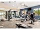 Community gym with treadmills, elliptical, weights, and views of the neighborhood at 10260 E White Feather Ln # 1022, Scottsdale, AZ 85262