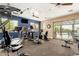 Well-equipped community gym with treadmills, elliptical machines, and natural light from the backyard at 10260 E White Feather Ln # 1022, Scottsdale, AZ 85262