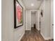 Hallway with wood floors and an adjacent half-bathroom and walk-in closet at 10260 E White Feather Ln # 1022, Scottsdale, AZ 85262