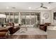Bright living room with wood floors, plush seating, and large sliding glass doors for ample natural light at 10260 E White Feather Ln # 1022, Scottsdale, AZ 85262