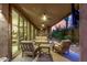 Expansive covered patio with comfortable seating, ceiling fans, and views of desert landscape at sunset at 10260 E White Feather Ln # 1022, Scottsdale, AZ 85262