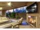 Relaxing outdoor living area featuring fireplace, TV, comfortable seating, and beautiful desert scenery at 10260 E White Feather Ln # 1022, Scottsdale, AZ 85262