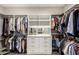Spacious walk-in closet with custom shelving, drawers, and ample hanging space for organization at 10260 E White Feather Ln # 1022, Scottsdale, AZ 85262