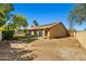Back of house features a private backyard with mature landscaping and solar panels at 10837 W Cottonwood Ln, Avondale, AZ 85392