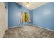 Colorful bedroom that features a ceiling fan, closet, and carpet at 10837 W Cottonwood Ln, Avondale, AZ 85392