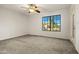 Neutral bedroom with ceiling fan and a window that let's the natural light in at 10837 W Cottonwood Ln, Avondale, AZ 85392