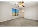 Well-lit bedroom that features a ceiling fan and a walk-in closet at 10837 W Cottonwood Ln, Avondale, AZ 85392