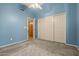 Blue bedroom with vaulted ceiling, carpet, and closet at 10837 W Cottonwood Ln, Avondale, AZ 85392