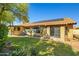 Exterior view of a home with lush backyard landscaping, pool, and solar panels at 10837 W Cottonwood Ln, Avondale, AZ 85392