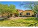 Inviting single-Gathering home with lush green lawn and mature landscaping showcasing curb appeal at 10837 W Cottonwood Ln, Avondale, AZ 85392