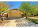 Single-story home featuring desert landscaping, a two-car garage, and a well-maintained lawn at 10837 W Cottonwood Ln, Avondale, AZ 85392