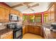 Well-lit kitchen with a bay window over the sink with stainless steel appliances at 10837 W Cottonwood Ln, Avondale, AZ 85392