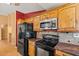 Open kitchen with stainless steel appliances, granite countertops, and custom wood cabinets at 10837 W Cottonwood Ln, Avondale, AZ 85392