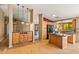 A spacious kitchen features wooden cabinets, stainless steel appliances and an island at 10837 W Cottonwood Ln, Avondale, AZ 85392