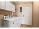 Functional laundry room with white cabinets, washer, and dryer at 10837 W Cottonwood Ln, Avondale, AZ 85392