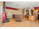 A spacious living room features a red fireplace, wood floors and a ceiling fan at 10837 W Cottonwood Ln, Avondale, AZ 85392
