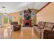 Bright living room boasts vaulted ceilings, a decorative fireplace, and large windows at 10837 W Cottonwood Ln, Avondale, AZ 85392