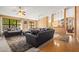 Bright living room with a large sectional sofa, wood floors, and large windows at 10837 W Cottonwood Ln, Avondale, AZ 85392