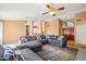Inviting living room featuring a gray sectional sofa and an open floor plan at 10837 W Cottonwood Ln, Avondale, AZ 85392
