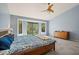 Spacious main bedroom with ceiling fan, carpet, and access to the outside through glass doors at 10837 W Cottonwood Ln, Avondale, AZ 85392