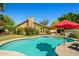 Inviting backyard pool with mature landscaping and a covered patio area at 10837 W Cottonwood Ln, Avondale, AZ 85392