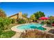 Lush backyard with a sparkling pool, mature landscaping, and a covered patio at 10837 W Cottonwood Ln, Avondale, AZ 85392
