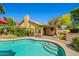 Inviting backyard pool with spa steps, mature landscaping, and a covered patio at 10837 W Cottonwood Ln, Avondale, AZ 85392