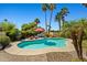 Refreshing backyard pool surrounded by lush tropical landscaping with lounge chairs and a red umbrella at 10837 W Cottonwood Ln, Avondale, AZ 85392