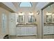Bright bathroom featuring double vanity sinks, ample counter space, and a decorative arched window at 10939 N 111Th St, Scottsdale, AZ 85259