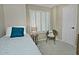 Charming bedroom featuring a twin bed, plantation shutters, and a cozy chair for reading at 10939 N 111Th St, Scottsdale, AZ 85259